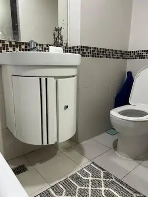 a bathroom with a sink and a toilet at Solemare Parksuites with balcony in Manila
