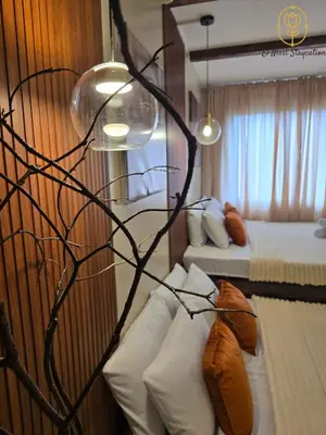 a hotel room with two beds and a chandelier at El Nissi Staycation, THE DELUXE CABIN, Enchanted Kingdom in Santa Rosa