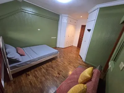 a bedroom with a bed and a couch in a room at Manila Gateway Hostel in Manila