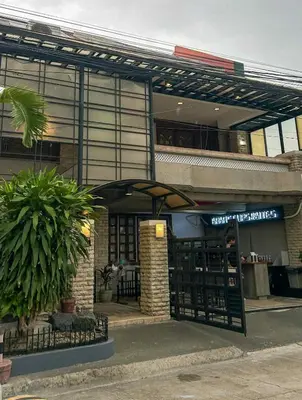 a building with an entrance to a restaurant at Manila Gateway Hostel in Manila