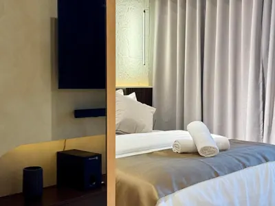 a bedroom with a bed with two towels on it at Stylish 1BR with balcony inside BGC at Uptown Parksuites - 20d in Manila