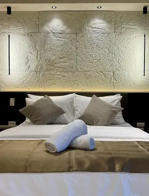 a bed with a blue towel on top of it at Stylish 1BR with balcony inside BGC at Uptown Parksuites - 20d in Manila