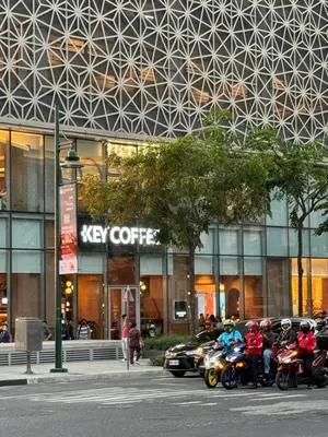 a group of people riding motorcycles in front of a building at Stylish 1BR with balcony inside BGC at Uptown Parksuites - 20d in Manila