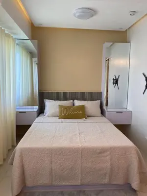 a bedroom with a large bed in a room at HomeSuiteHome, Shore 3 Residences Moa Complex, Pasay City in Manila