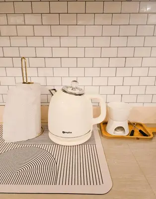 a tea kettle and a toaster on a kitchen counter at NEMM Staycation in Manila
