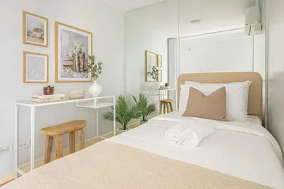 a bedroom with a bed with two towels on it at 2 BR Golf View Loft Timeless Charm in Avant BGC in Manila