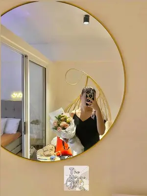 a woman taking a picture of herself in a mirror at Staycation by Darvy in Manila