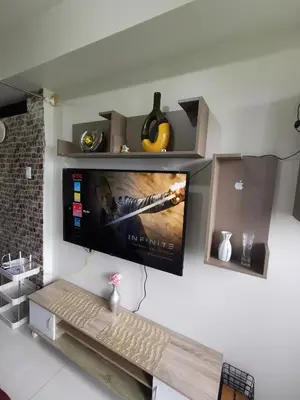 a flat screen tv hanging on a wall at Aldo mall of Asia condotel in Manila