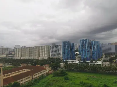 a group of tall buildings in a city at Aldo mall of Asia condotel in Manila