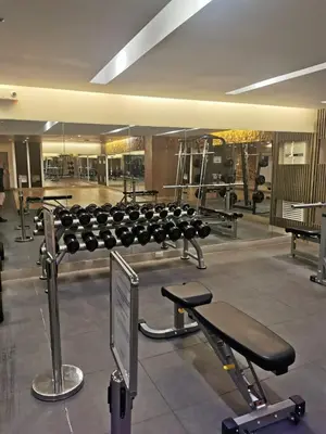 a gym with a row of chairs and tables at Aldo mall of Asia condotel in Manila