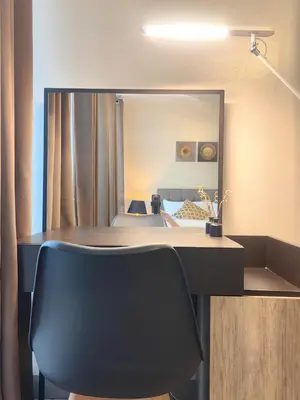 a desk with a chair in front of a mirror at Uptown BGC Spacious 1BR Unit by Terravista - Prague Suite in Manila
