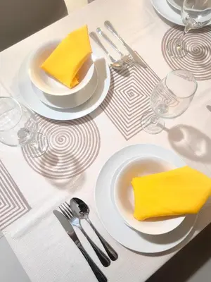 a table with plates and utensils and yellow napkins at Uptown BGC Spacious 1BR Unit by Terravista - Prague Suite in Manila