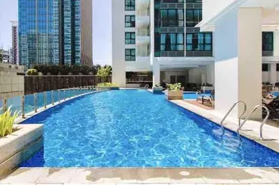 a swimming pool in the middle of a building at Uptown BGC Spacious 1BR Unit by Terravista - Prague Suite in Manila