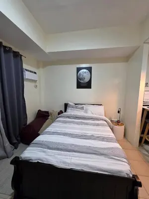 a bedroom with a large bed in a room at Pioneerwoodlands Mandaluyong Studio Unit in Manila