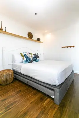 a large bed in a room with a wooden floor at Glass House w Stunning View in Poblacion Makati in Manila