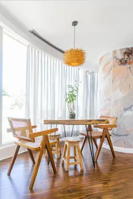 a dining room with a wooden table and chairs at Glass House w Stunning View in Poblacion Makati in Manila