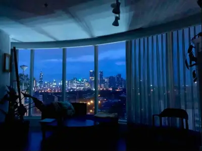 a room with a large window with a view of a city at Glass House w Stunning View in Poblacion Makati in Manila