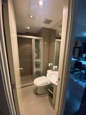 a bathroom with a toilet and a sink at 56th Floor -Sauna - Makati View - Knightsbridge Residences in Manila