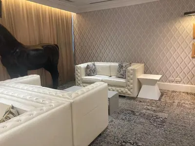 a living room with two white couches and a horse statue at 56th Floor -Sauna - Makati View - Knightsbridge Residences in Manila