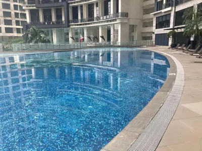 a large blue swimming pool in a building at 56th Floor -Sauna - Makati View - Knightsbridge Residences in Manila