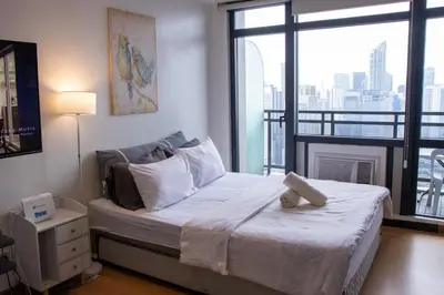 a bedroom with a bed and a large window at C-Studio,Best Sunset Pool,Luxury,Hotel Style in Manila