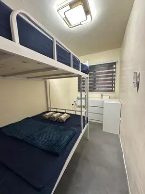 a bedroom with two bunk beds and a bathroom at Canlubang Transient house Asia 1 near 7-11 in Calamba