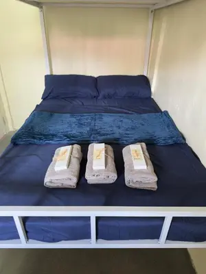 a bed with two towels and two pillows on it at Canlubang Transient house Asia 1 near 7-11 in Calamba
