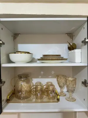 a shelf with dishes and glasses on it at Canlubang Transient house Asia 1 near 7-11 in Calamba