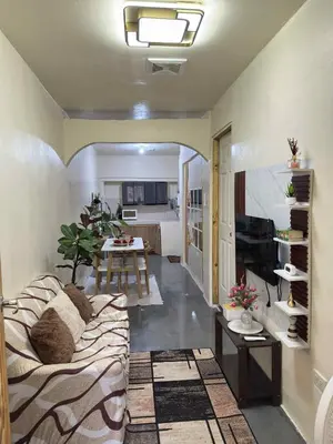a living room with a couch and a table at Canlubang Transient house Asia 1 near 7-11 in Calamba