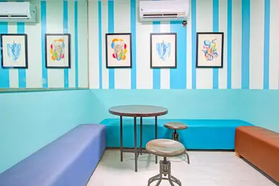 a waiting room with a table and two stools at Belvilla College Residences In University Belt, Metro Manila in Manila
