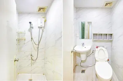 a bathroom with a shower and a toilet and a sink at Belvilla College Residences In University Belt, Metro Manila in Manila