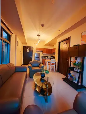 a living room with a couch and a table at LeMoon's Chill with beautiful view-1 Bedroom in Manila