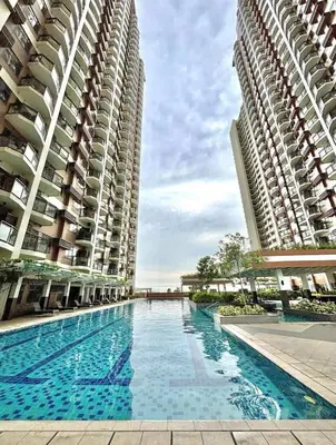 two tall buildings with a swimming pool between them at LeMoon's Chill with beautiful view-1 Bedroom in Manila