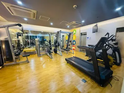 a gym with treadmills and cardio equipment in a room at Walking Distance Condo Across Naia T3 Airport in Manila