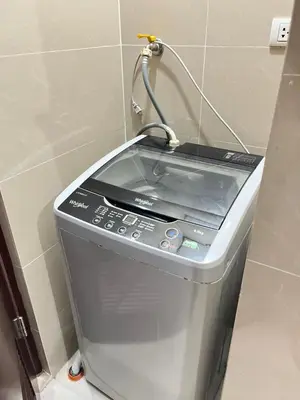 a washing machine sitting in a corner of a room at Walking Distance Condo Across Naia T3 Airport in Manila