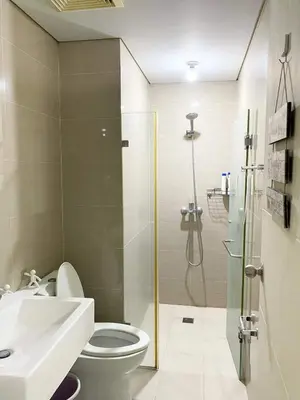 a bathroom with a shower and a toilet and a sink at 5min Staycation Away from Naia Terminal 3 Airport in Manila