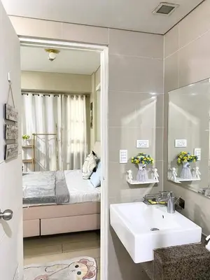 a bathroom with a sink and a bed and a mirror at 5min Staycation Away from Naia Terminal 3 Airport in Manila