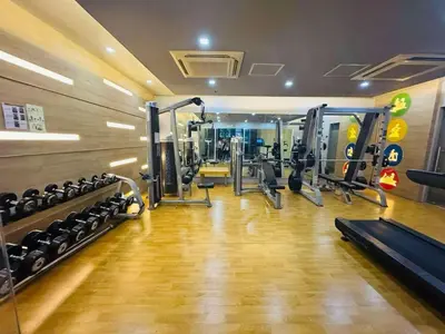a gym with several treadmills and machines at Lovely Condo Across NAIA T3 Newport with WiFi in Manila