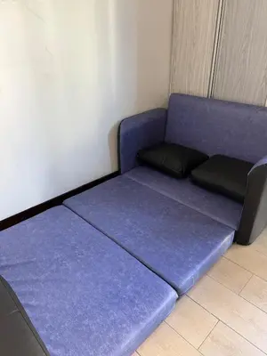 a purple bed in a corner of a room at Lovely Condo Across NAIA T3 Newport with WiFi in Manila