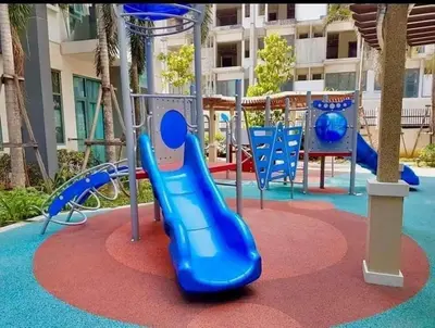 a playground with a blue slide in a park at Kyendenz Condotel-Across Naia T3 Pool View with Wifi in Manila