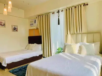 a bedroom with two beds and a window at Staycation Unit at Two Palm Across Naia T3 with WIFI in Manila