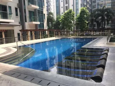 a large swimming pool in a city with buildings at Staycation Unit at Two Palm Across Naia T3 with WIFI in Manila
