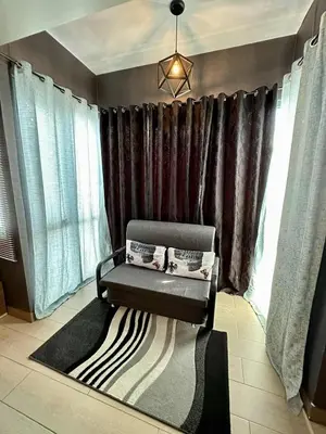 a room with a bench in front of some windows at Homey Studio at Two Palm Tree Across NAIA T3 Airport in Manila