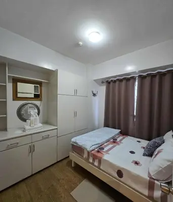 a small bedroom with a bed and a window at Staycation in Paranaque by Indigo in Manila