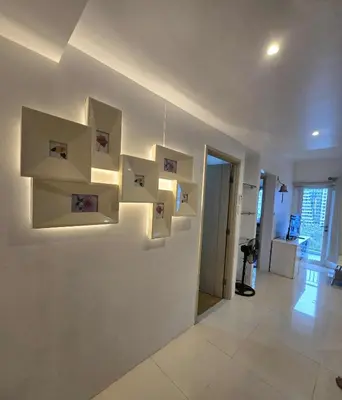 a room with white walls with pictures on the wall at Staycation in Paranaque by Indigo in Manila