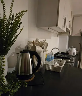 a tea kettle on a counter in a kitchen at Staycation in Paranaque by Indigo in Manila