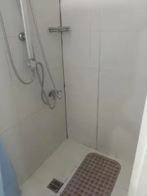 a bathroom with a shower with a mat in it at Luxurious Condo in the Heart of Makati Philippines in Manila