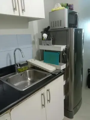 a kitchen with a sink and a refrigerator at Luxurious Condo in the Heart of Makati Philippines in Manila
