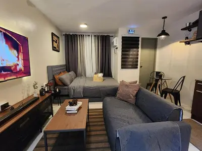 a living room with a couch and a bed at MetacasaStaycations-beside EK with Fireworks view in Santa Rosa