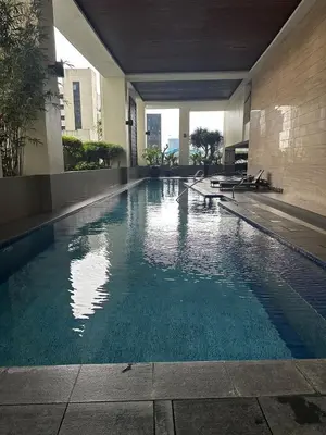 an empty swimming pool in a building at Spacious Studio in Mosaic Tower no Balcony in Manila